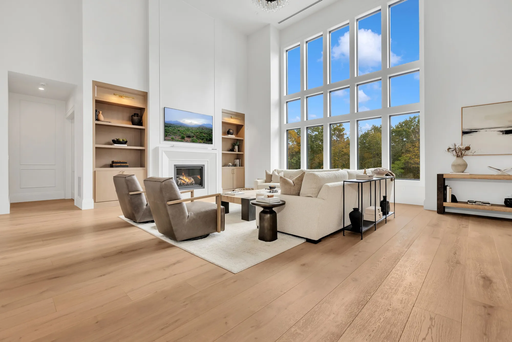 Oak floor in a two-story living room with tall windows